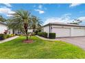Beautiful home exterior with a two-car garage, lush landscaping, and a paved walkway at 3130 Ringwood Mdw # 44, Sarasota, FL 34235