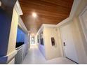 Hallway with white trim, neutral walls, and wood ceiling at 3506 54Th W Dr # 103, Bradenton, FL 34210