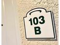 Close-up of unit 103 B sign on the building's exterior at 3506 54Th W Dr # 103, Bradenton, FL 34210