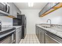 Updated kitchen boasts granite countertops, stainless steel appliances, and ample cabinet space at 3781 59Th W Ave # 3781, Bradenton, FL 34210