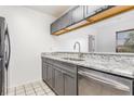 This kitchen features gray cabinets, granite countertops, and stainless steel appliances at 3781 59Th W Ave # 3781, Bradenton, FL 34210