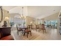 Elegant dining room with a large window, chandelier, and a formal dining table perfect for entertaining guests at 3984 Lyndhurst Ct, Sarasota, FL 34235