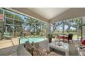 Inviting screened-in patio with a private pool, comfortable seating, and lush landscaping for outdoor relaxation at 3984 Lyndhurst Ct, Sarasota, FL 34235