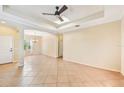 Bright, spacious living room featuring tile floors, ceiling fan, and elegant architectural details at 4016 Azurite Way, Bradenton, FL 34211