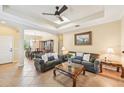 Inviting living room with tile flooring, a ceiling fan, and an open layout to the dining area at 4016 Azurite Way, Bradenton, FL 34211