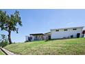 Beautiful home with a covered patio and well-maintained backyard on a sunny day at 4111 E 13Th E St, Ellenton, FL 34222