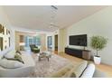 Bright living room with sliding glass doors to the lanai, and light wood flooring at 4313 Carol Ann Rd # 20, Sarasota, FL 34233