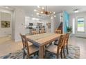 The dining room features a stylish chandelier and neutral décor at 4548 Chinkapin Dr, Sarasota, FL 34232