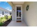 Home's front door and entry way, decorated with hanging ornaments and butterfly decorations at 5227 Aqua Breeze Dr, Bradenton, FL 34208