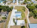 Aerial view of a home, showing a large yard with a circular driveway, and a gravel parking area for boats and RVs at 612 Shore Rd, Nokomis, FL 34275