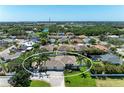 Aerial view showcasing a charming neighborhood with mature trees and a nearby lake at 7420 Tuttle Ave, Sarasota, FL 34243