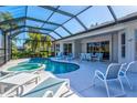 Screened in pool and spa with ample patio seating, offering a relaxing outdoor living space at 7582 Camden Harbour Dr, Bradenton, FL 34212