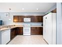 Kitchen featuring essential appliances, ample cabinets, and neutral countertop, offering functionality and style at 1122 42Nd E Ter, Bradenton, FL 34208