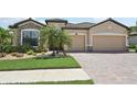Charming single-Gathering home with a two-car garage, well-maintained landscaping, and brick driveway at 13587 Vancanza Dr, Venice, FL 34293