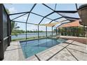 Gorgeous screened-in pool area with a spa and peaceful lake views, perfect for relaxation at 13587 Vancanza Dr, Venice, FL 34293