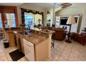 Open kitchen and living area featuring a breakfast bar, updated appliances, and a view to the patio at 1620 San Silvestro Dr, Venice, FL 34285