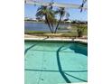Inviting pool area offers serene water views, palm trees, and an ideal setting for relaxation at 1620 San Silvestro Dr, Venice, FL 34285