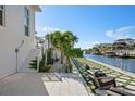 Backyard patio featuring a tiled patio and landscape design with water views at 1643 Stanford Ln, Sarasota, FL 34231