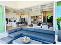 Bright living room with modern furniture flows into a chef's kitchen, perfect for entertaining at 1643 Stanford Ln, Sarasota, FL 34231