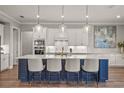 Stylish kitchen with a large island, pendant lighting, and modern stainless steel appliances at 16434 Slate Pl, Bradenton, FL 34211