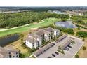 Aerial view of condo complex showcasing its lush surroundings, golf course, and parking at 17510 Gawthrop Dr # 208, Bradenton, FL 34211
