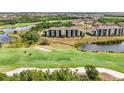 Aerial view showcasing the golf course and condo complex nestled amidst lush greenery and ponds at 17510 Gawthrop Dr # 208, Bradenton, FL 34211