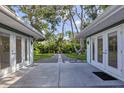 Backyard featuring a stone pathway leading to a bench, surrounded by lush greenery and well-maintained lawns at 1773 South Dr, Sarasota, FL 34239