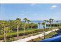 Scenic balcony view overlooking tropical foliage, trees, and the beautiful bay at 2120 Harbourside Dr # 621, Longboat Key, FL 34228