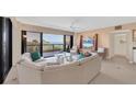 Bright living room featuring a large sectional sofa, floor to ceiling windows, and water views at 2120 Harbourside Dr # 621, Longboat Key, FL 34228