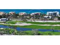 Aerial view showcasing the condo building's proximity to a golf course and other local buildings at 2185 Gulf Of Mexico Dr # 243, Longboat Key, FL 34228