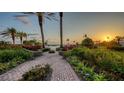 Scenic walkway amidst colorful landscaping leads to stunning sunsets over the ocean at 2185 Gulf Of Mexico Dr # 243, Longboat Key, FL 34228