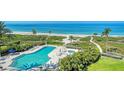 Resort-style pool and hot tub with lush landscaping offer a relaxing oasis by the beach at 2185 Gulf Of Mexico Dr # 243, Longboat Key, FL 34228