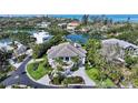 Stunning aerial view of a waterfront property surrounded by lush greenery and serene waterways at 244 Cedar Park Cir, Sarasota, FL 34242