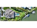 Overhead view of home featuring a backyard pool, lush lawn, and private boat dock at 244 Cedar Park Cir, Sarasota, FL 34242