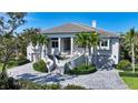 Elegant two-story home with a beautifully landscaped front yard and a circular driveway at 244 Cedar Park Cir, Sarasota, FL 34242