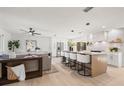 Open-concept kitchen with a large island, modern appliances, and stylish barstool seating at 2720 Pinewood Ct, Clearwater, FL 33761