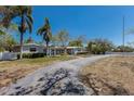Spacious single-story home with a long driveway and beautiful mature trees at 2723 59Th St, Sarasota, FL 34243