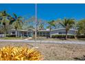 Spacious single-story home with a long driveway and beautiful mature trees at 2723 59Th St, Sarasota, FL 34243
