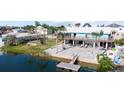 Beautiful waterfront backyard featuring a patio with a firepit, and a dock on the canal at 3416 Crape Myrtle Dr, Hernando Beach, FL 34607