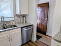 Well-lit kitchen featuring new appliances, granite countertops, a tiled backsplash, and a stainless steel sink at 3744 Lake Bayshore Dr # K-503, Bradenton, FL 34205