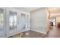 Bright foyer with decorative front door and tile flooring at 3761 Countryside Rd, Sarasota, FL 34233