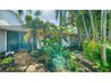 Landscaped walkway leading to the front entrance with lush tropical foliage at 3761 Countryside Rd, Sarasota, FL 34233