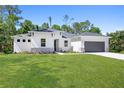 Inviting single-story home with a well-maintained lawn, stone veneer accents, and attached garage at 4008 Antelope Ter, North Port, FL 34286