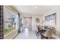 Bright dining room with large window, modern decor, neutral colors and tile flooring at 5037 Rocky Coast Pl, Palmetto, FL 34221