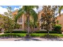 Delightful peach-colored townhome with manicured landscaping, a small balcony and tile roof at 5388 Davini St, Sarasota, FL 34238