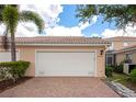 Spacious two-car garage featuring a brick paver driveway, set in a well-kept residential area at 5388 Davini St, Sarasota, FL 34238