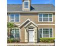 Charming townhome featuring classic architecture, a welcoming entrance, and lovely landscaping at 5531 Rosehill Rd # 204, Sarasota, FL 34233