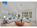 Bright living room featuring high ceilings, neutral décor, and plenty of natural light at 5531 Rosehill Rd # 204, Sarasota, FL 34233