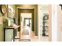 Inviting hallway with stylish decor leading to a bright and airy living space at 5684 Blue Reef Place, Nokomis, FL 34275
