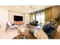 Comfortable living room with modern furniture, large TV, and view of the outdoors at 5684 Blue Reef Place, Nokomis, FL 34275